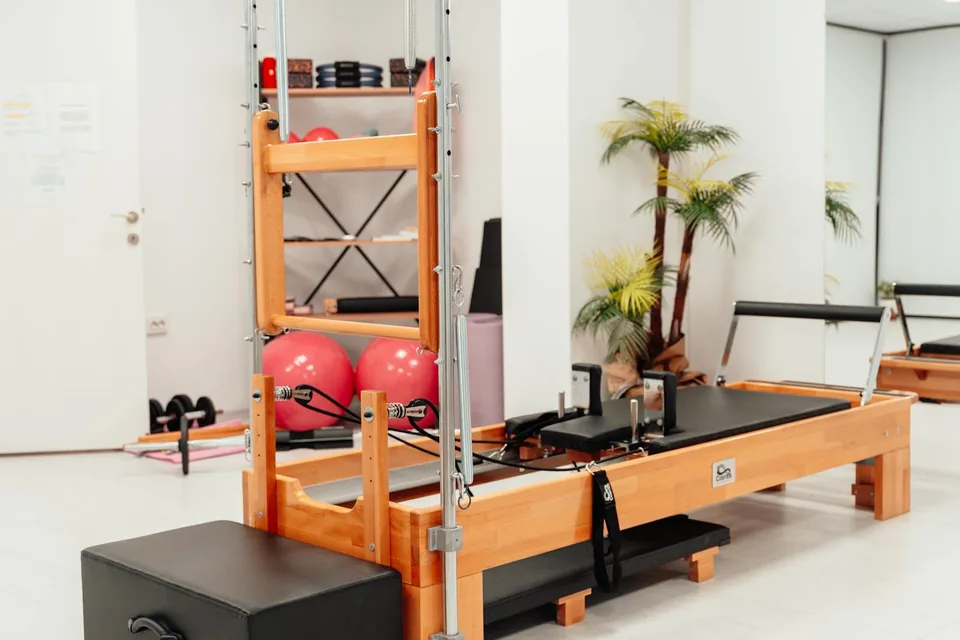 Pilates reformer with tower in a bright home studio