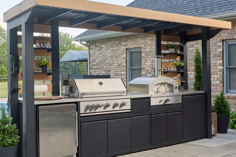 Outdoor kitchen with pizza oven, grill, and refrigeration