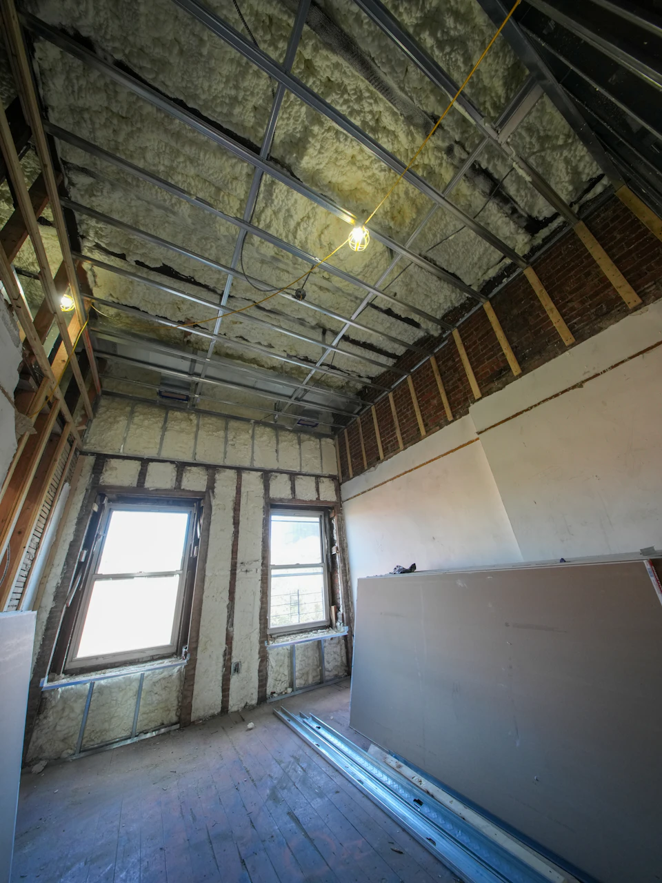 Spray foam insulation applied between wall studs during a Bergen County home energy upgrade