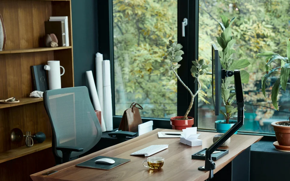 Home office desk with laptop in front of a window